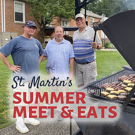 Three men grilling burgers outdoors during St. Martin's Summer Meet & Eats event at St. Martin's-in-the-Field Episcopal Church.